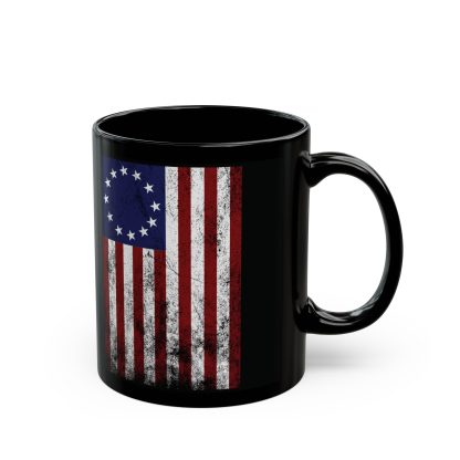 A black ceramic mug featuring America’s original Betsy Ross flag design. The flag, with 13 stars arranged in a circle representing the original colonies, is printed in high-quality sublimation on the side of the mug. The mug has a glossy finish, an easy-grip C-shaped handle, and is available in both 11-ounce and 15-ounce sizes. Ideal for patriotic Americans and history lovers, this sturdy, BPA-free, and microwave-safe mug combines practicality with a touch of Revolutionary War-era pride.