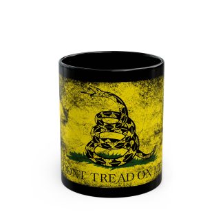 A black ceramic mug featuring the iconic Gadsden Flag with the slogan "Don’t Tread on Me." This bold design is perfect for patriots, history buffs, and anyone who’s fed up with being stepped on. Available in 11oz and 15oz sizes, the mug is microwave and dishwasher safe, made from lead and BPA-free durable ceramic. The sublimation print ensures the design stays sharp, making it the perfect statement piece for anyone who values their rights and freedoms while enjoying their coffee.