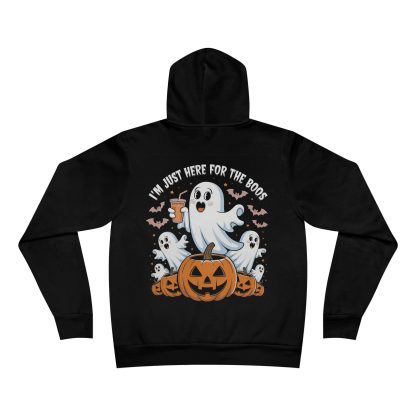 An unisex fleece pullover hoodie featuring a playful Halloween design with pumpkins and friendly ghosts, including a ghost holding an adult beverage. The phrase "I'm Just Here for the Boos" is printed across the front, adding a humorous touch to the spooky theme. The hoodie has a pouch-style front pocket, a white drawstring on the hood, and ribbing on the cuffs and waistband for a snug fit. Made of a soft cotton-polyester blend, this cozy hoodie is perfect for celebrating Halloween while enjoying a festive drink.