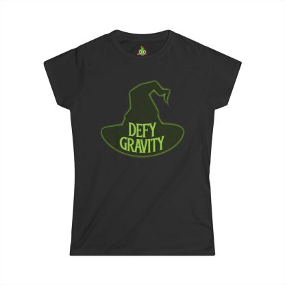 Women's softstyle t-shirt featuring Elphaba's witch hat and the phrase 'Defy Gravity' printed in bold lettering. The semi-fitted design in light fabric showcases a feminine cut with shortened sleeves, perfect for fans of Wicked or anyone seeking an empowering, stylish look.