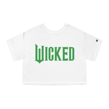 Women's cropped t-shirt featuring a minimalist 'Wicked' design, available in Elphaba's green or Glinda's pink. Made from 100% cotton jersey with the iconic Champion 'C' logo on the sleeve, showcasing a trendy and durable cropped fit perfect for Broadway fans.