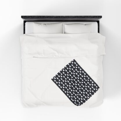 Cute ghosts in a white sheet wearing pink and purple bows on velveteen blanket.