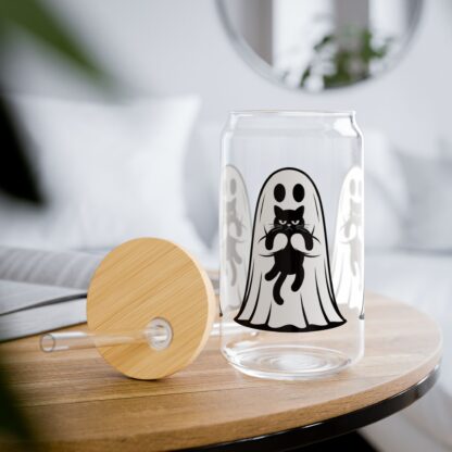 Cute ghost in a white sheet showing off his grumpy black cat on a 16oz sipper glass.