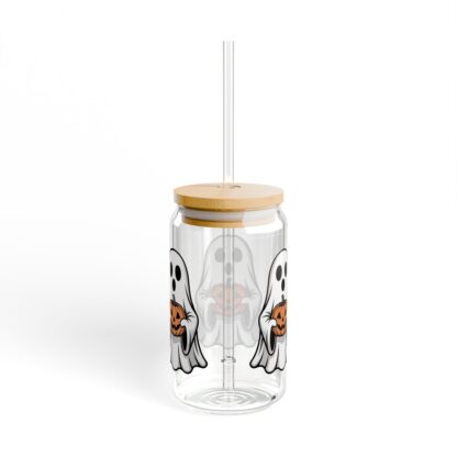 Cute ghost in a white sheet holding a jack-o-lantern on a 16oz sipper glass.