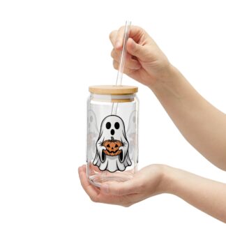Cute ghost in a white sheet holding a jack-o-lantern on a 16oz sipper glass.